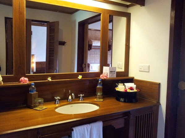 A wooden bathroom vanity with a large mirror, a sink, and a towel rack. - Inle Lake View Resort & Spa (Nyaungshwe)