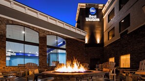 A hotel lobby with a fire feature, outdoor seating, and a pool area. - Best Western Sevierville/Kodak Inn (Kodak)