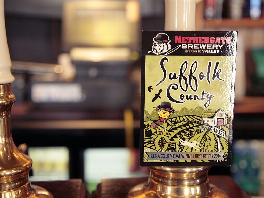 A beer tap labeled 'Suffolk County' with a gold medal logo.