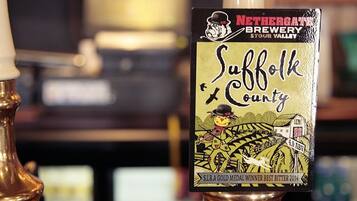 A beer tap labeled 'Suffolk County' with a gold medal logo.