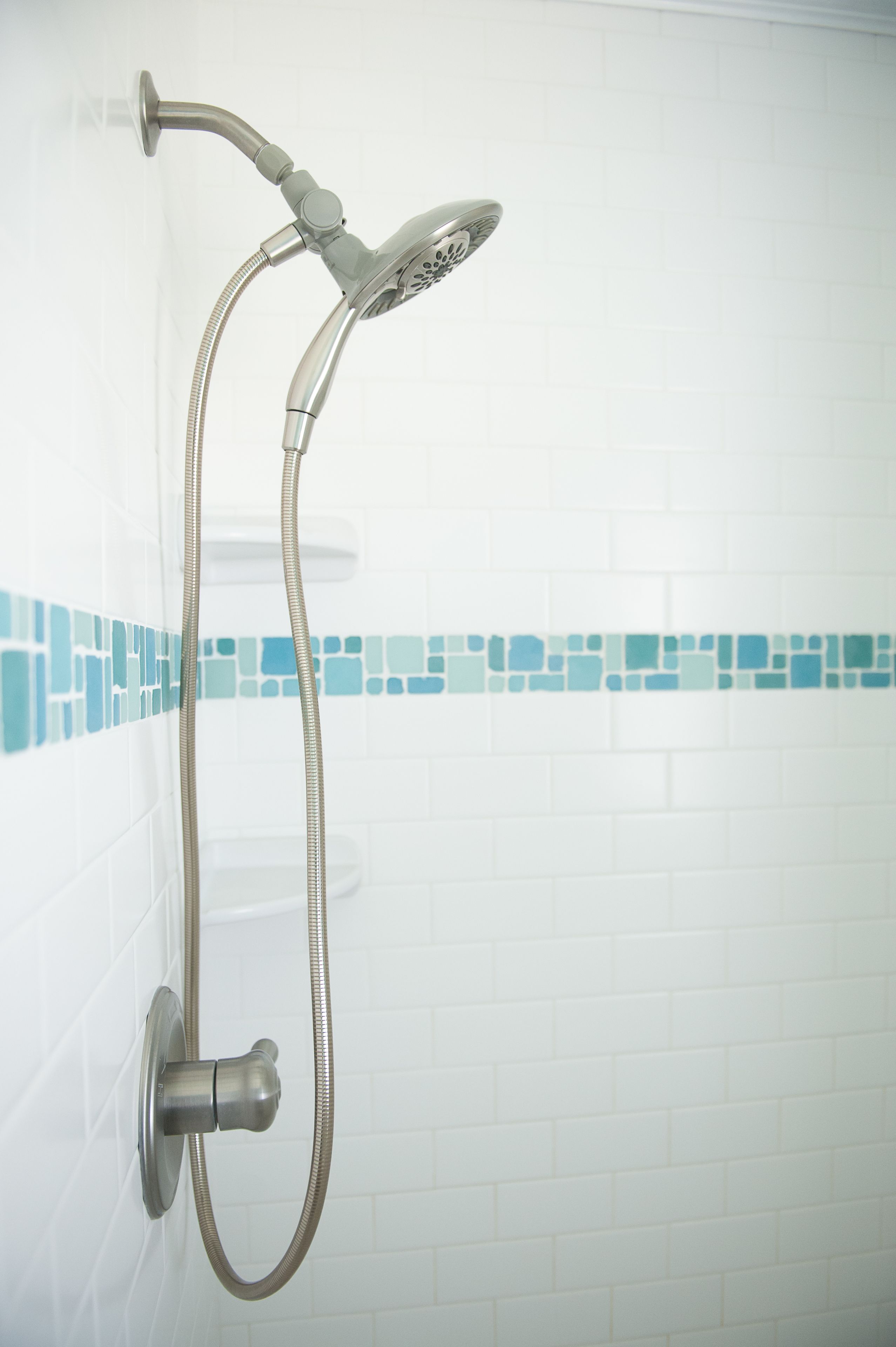 A shower with a handheld showerhead and a flexible hose.