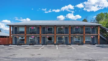 A two-story motel with a parking lot in front.