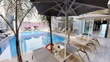 Seasonal outdoor pool, open 9:30 AM to 8:00 PM, pool umbrellas