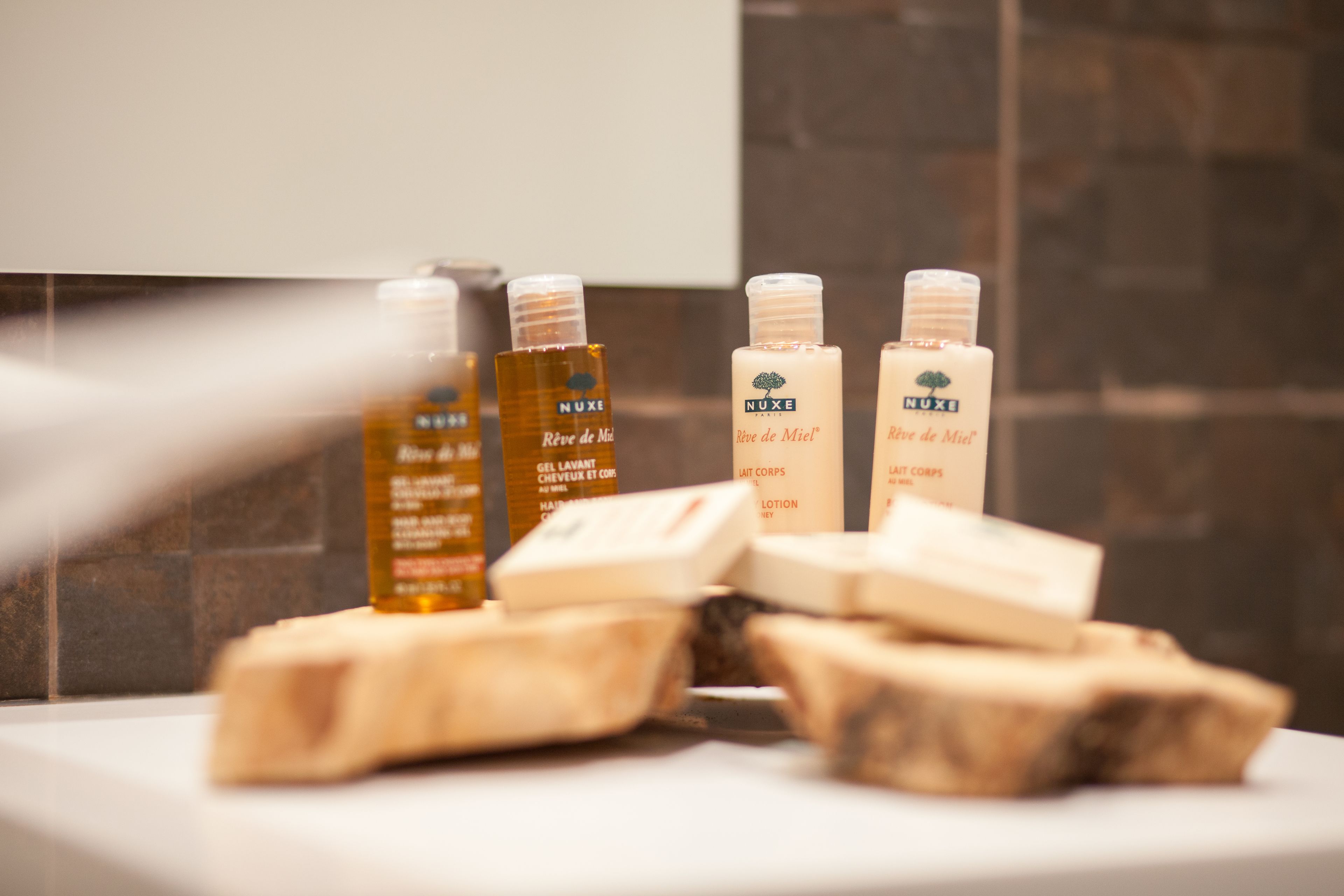 A bathroom with toiletries including soap and lotion bottles.