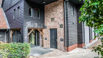 A modern building with a brick facade and wooden siding.