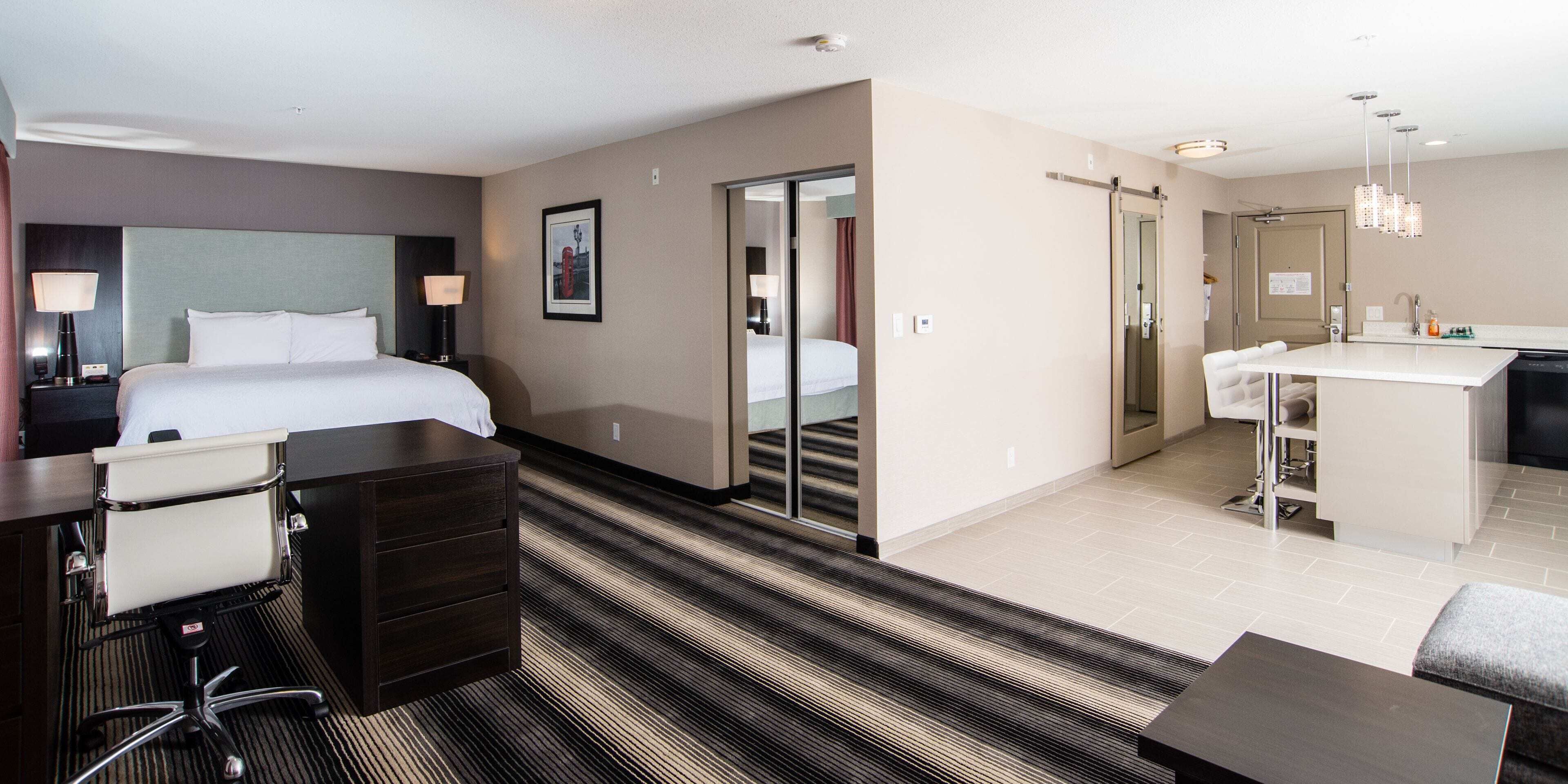 Premium bedding, desk, laptop workspace, iron/ironing board