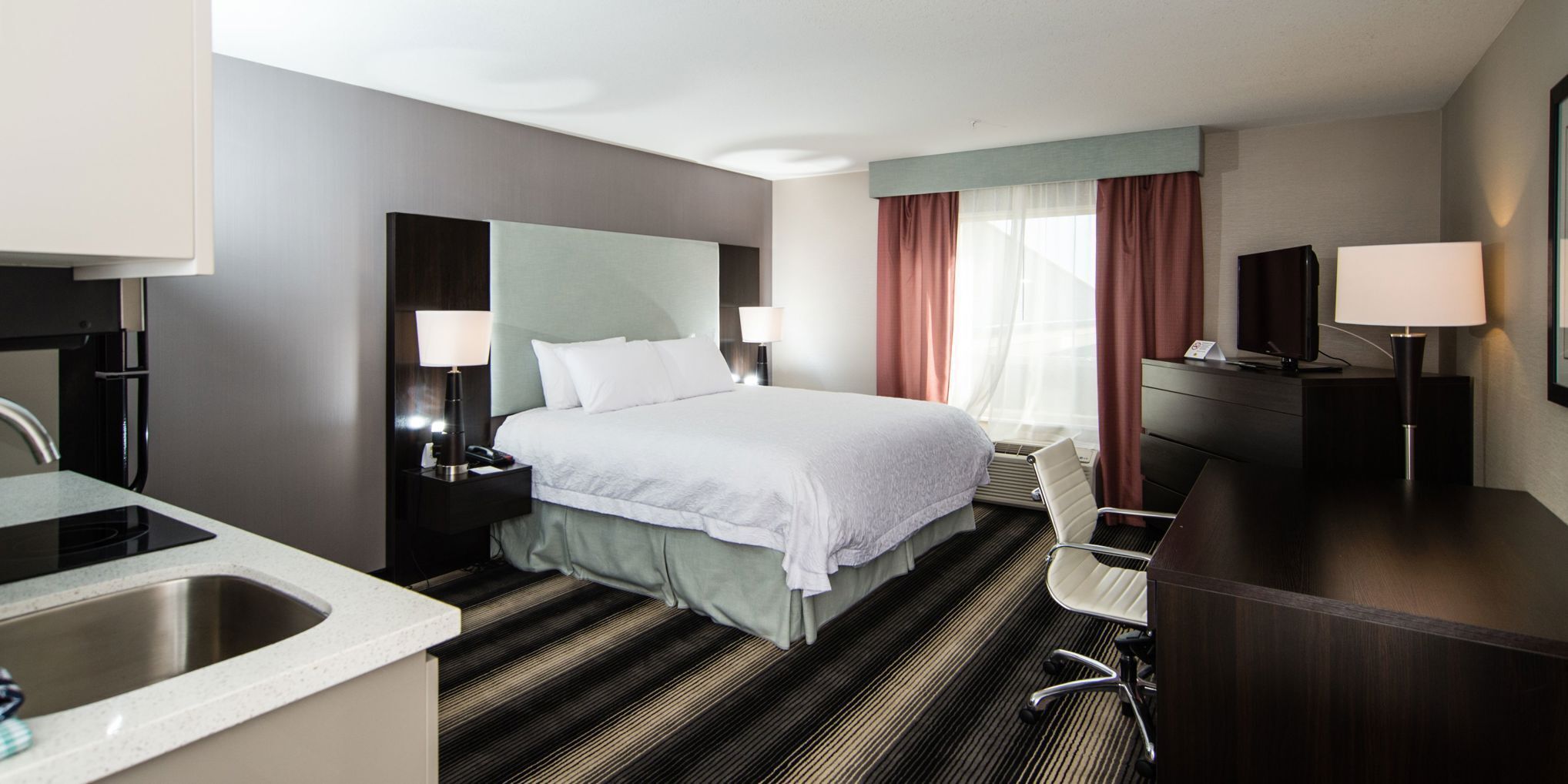 Premium bedding, desk, laptop workspace, iron/ironing board