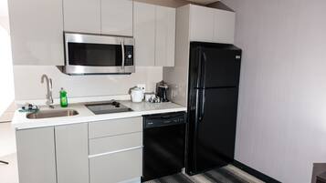 A modern kitchen with stainless steel appliances, a dishwasher, and a sink.