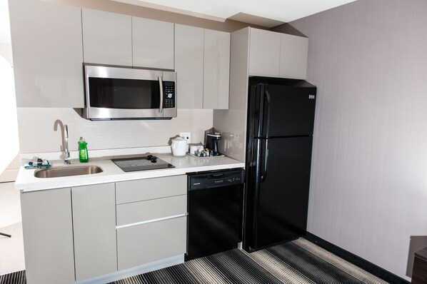A modern kitchen with stainless steel appliances, a dishwasher, and a sink.