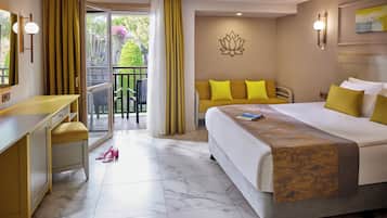 A hotel room with a bed, a desk, a chair, a balcony with a view, and a door.