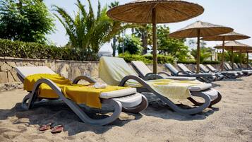 On the beach, beach cabanas, sun-loungers, beach umbrellas