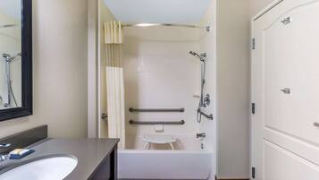 A bathroom with a bathtub, a shower, a toilet, and a sink.