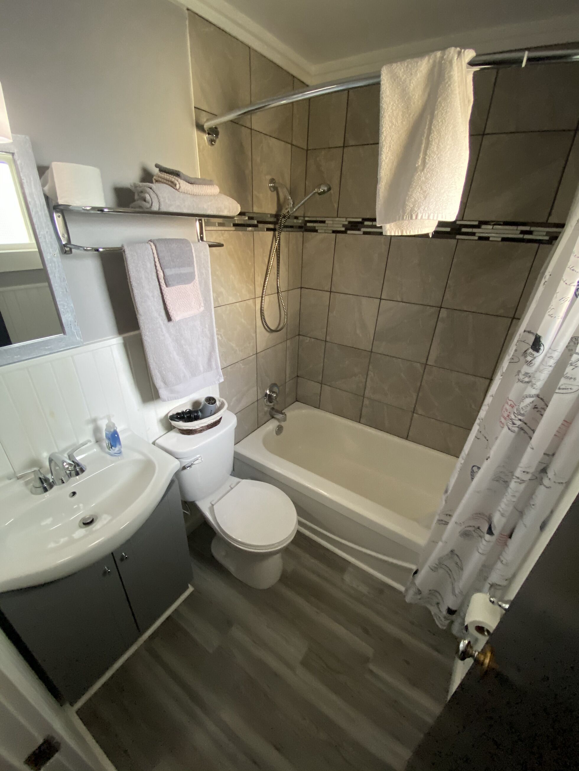 A bathroom with a sink, toilet, bathtub, and shower.