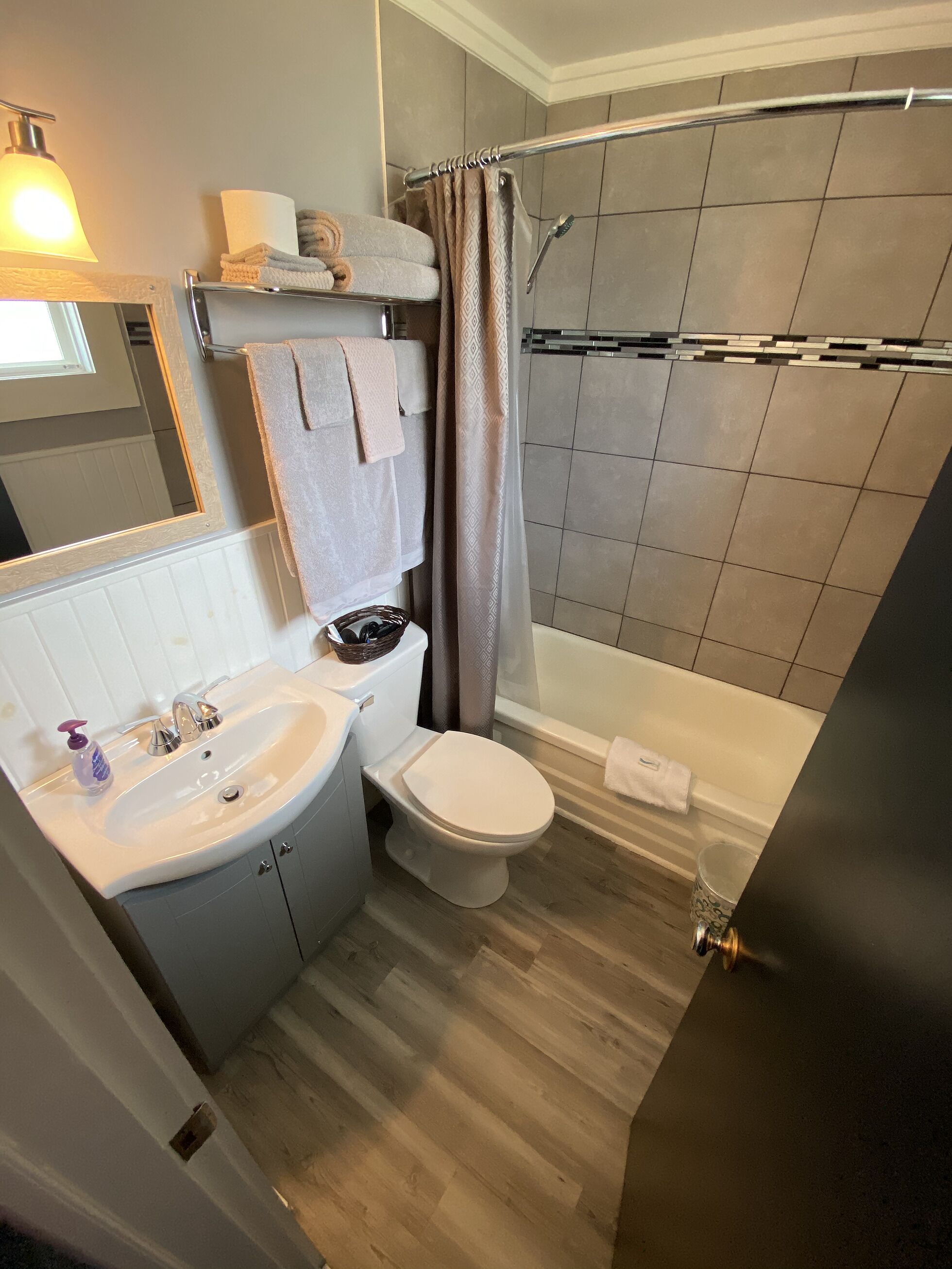 A modern bathroom with a sink, toilet, and shower area.