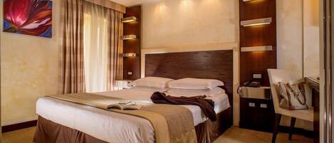 A hotel room with a large bed, a bedside table with a lamp, a chair, and a painting on the wall.