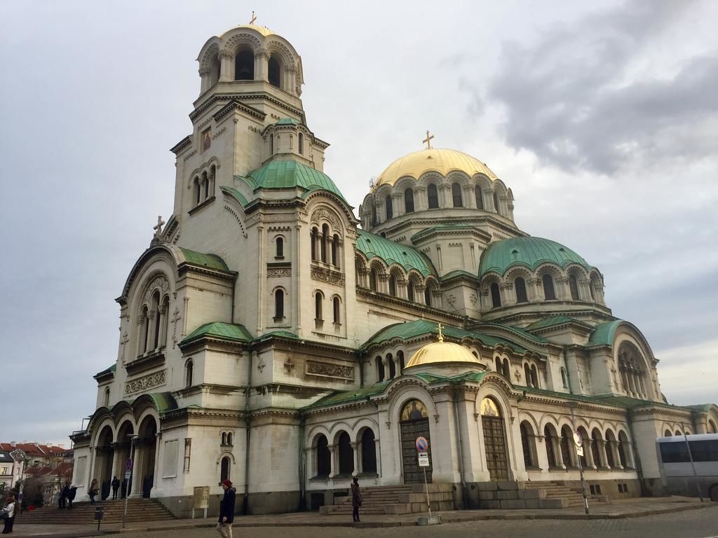 A large, historic church with multiple domes and a prominent bell tower.
