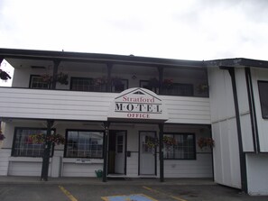 Un edificio de dos pisos con un cartel que dice 'Stratford Motel Office'.