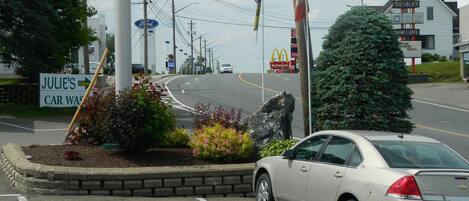 A motel sign with a restaurant, a McDonald's, and a furniture store.