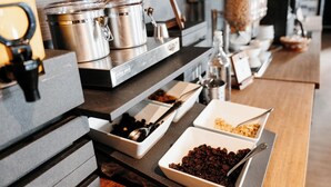 A buffet setup with various dishes and cooking equipment. - Manoir Belle Plage (Carleton-sur-Mer)