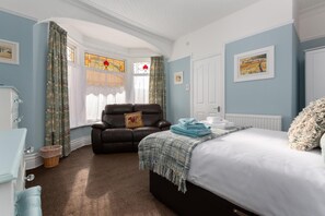 A bedroom with a bed, a chair, a dresser, and a window with curtains. - The Beechcliffe Hotel - Over 35's Only (Blackpool)