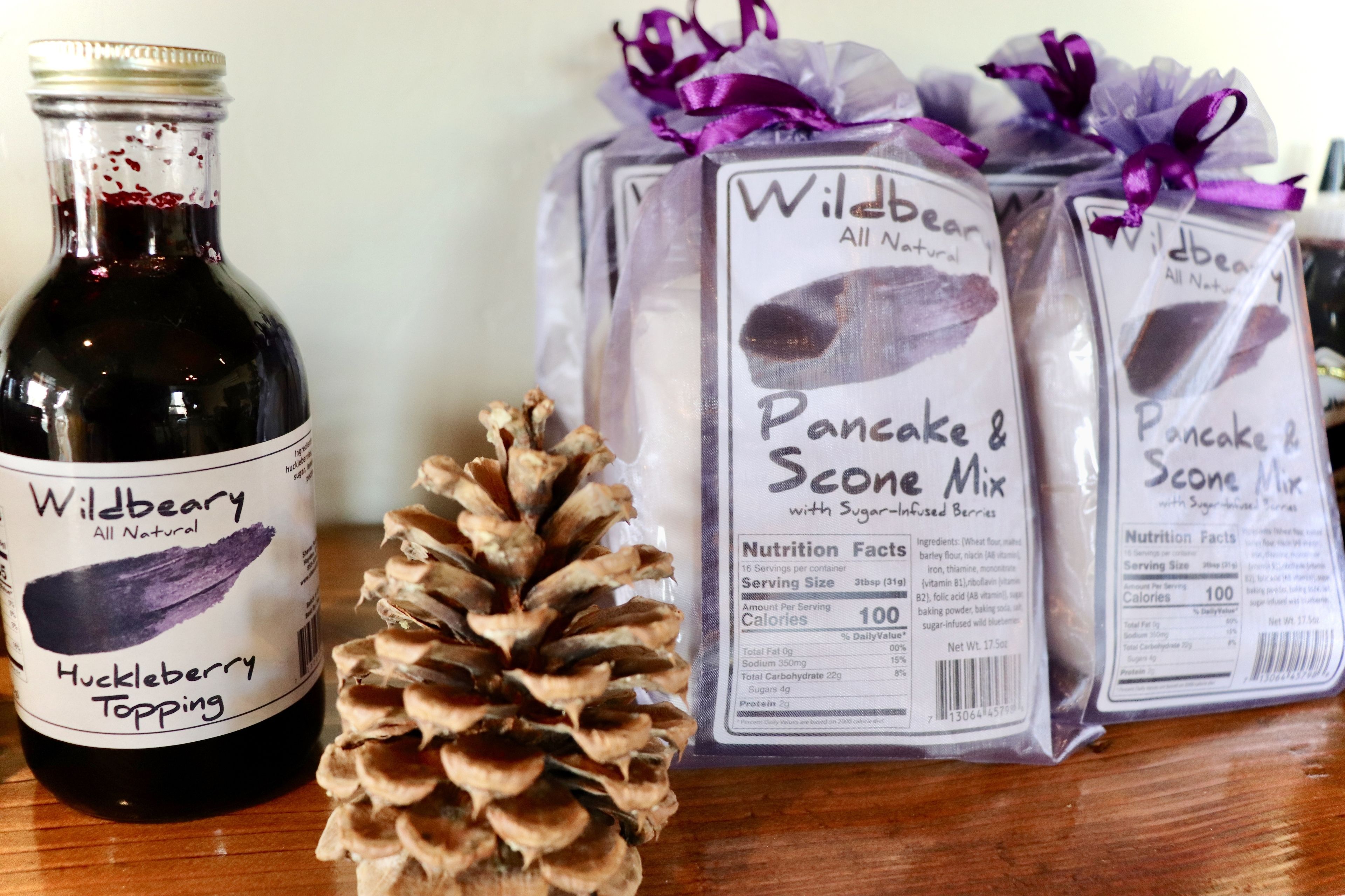 A bottle of Wildberry Huckleberry Topping and packages of Wildberry Pancake & Scone Mix.