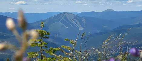A mountainous landscape with a clear sky and distant mountains.