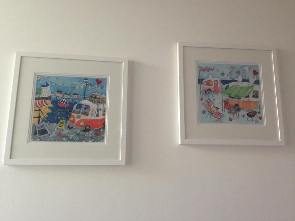 Two framed artworks on a wall.