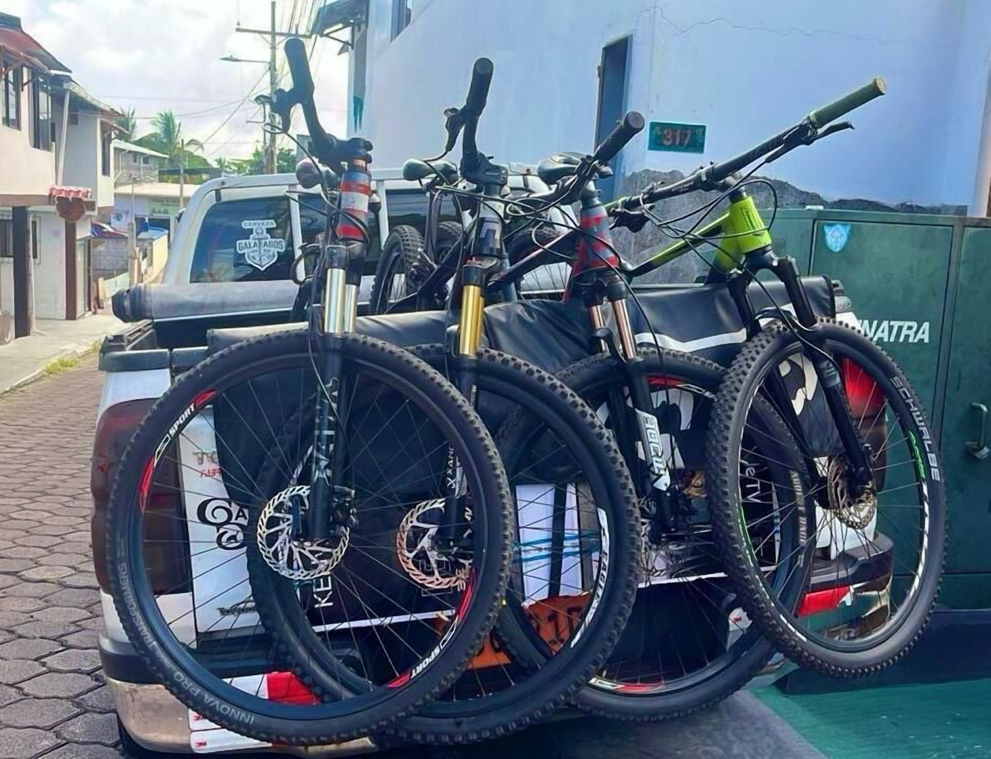 A vehicle with three bicycles mounted on the back.