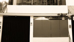 A multi-story building with a garage door, large windows, and a sign that reads "ZAVALA".