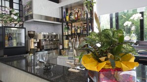 A modern kitchen with a marble countertop, a wine cooler, and a variety of kitchen appliances. - Hotel Penny (Rimini)