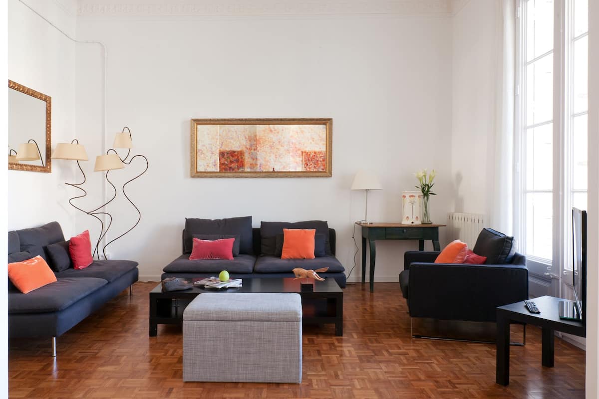 A modern living room with two sofas, a coffee table, and a side table.