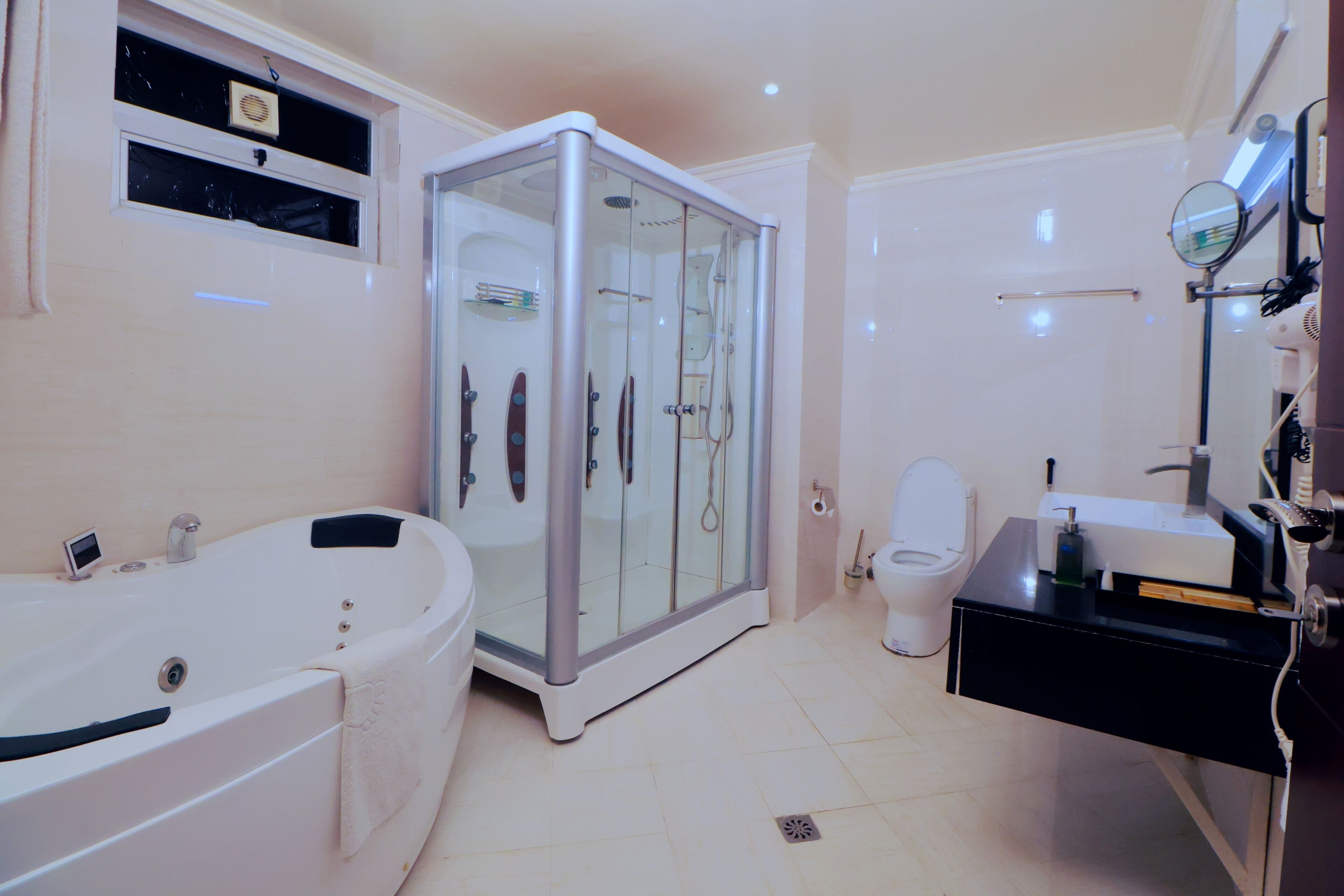 Ein Badezimmer mit Badewanne, einer Duschkabine, Toilette und Waschbecken.
