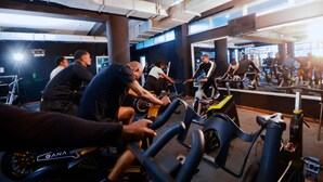 A gym with stationary bikes, mirrors, and exercise equipment.