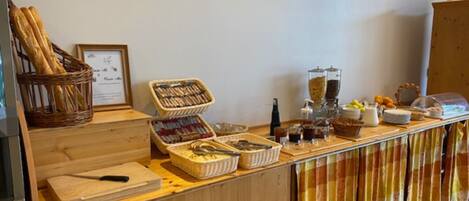 A buffet setup with various food items and utensils.