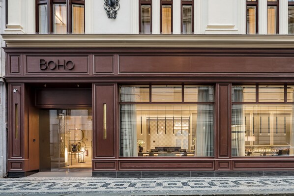A building facade with a large glass window displaying a well-lit interior. -  BoHo Prague Hotel, Small Luxury Hotels (Prague)