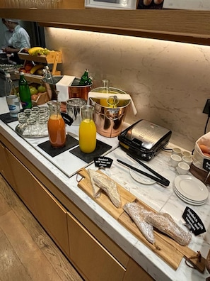 Enjoy a variety of sandwiches, fruits, and beverages at our buffet.