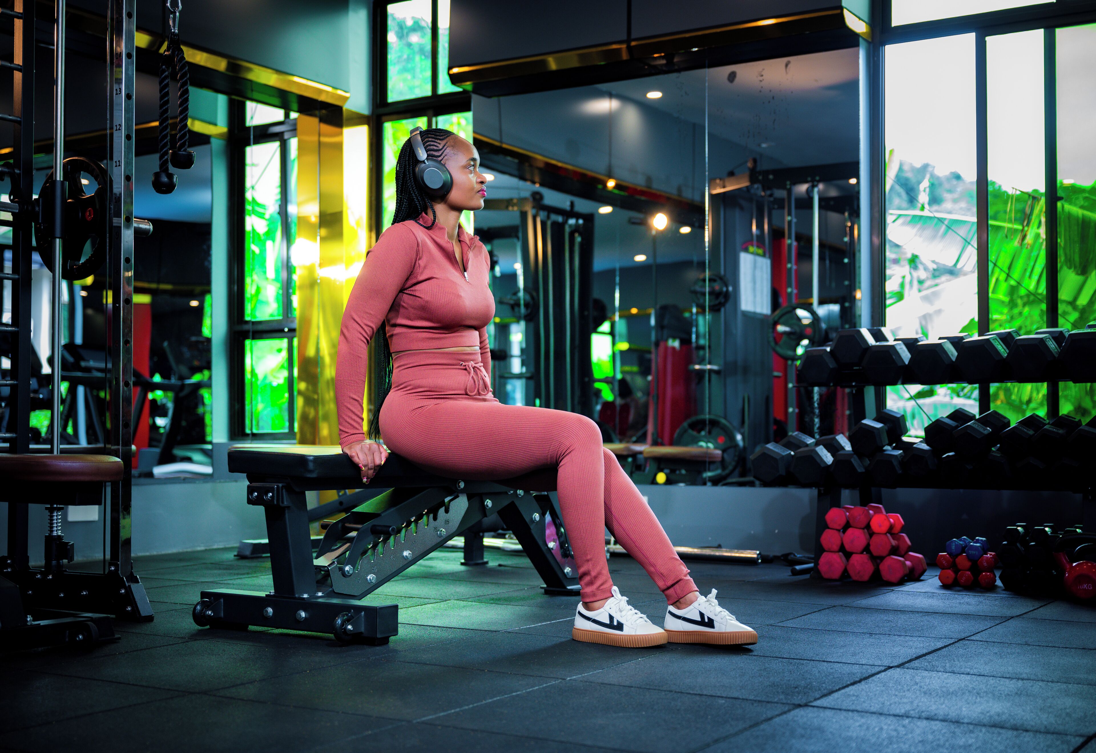 A gym with exercise equipment, a bench, and weights.