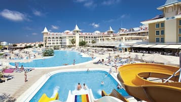 Relax by the pool surrounded by sun loungers and umbrellas, with a water slide for added fun.