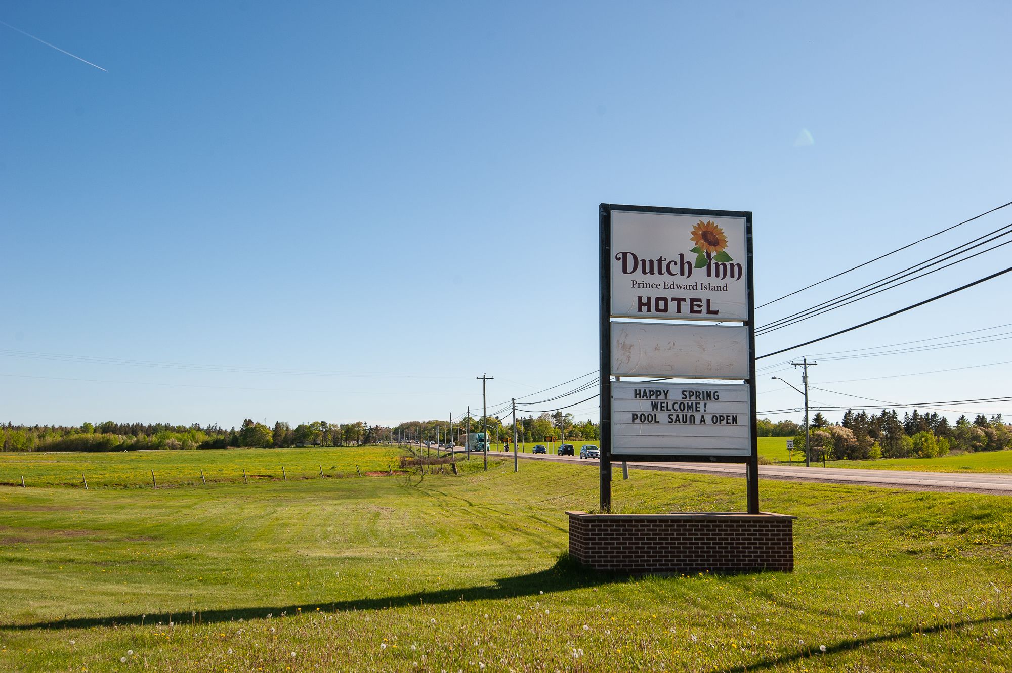 A sign for Dutch Inn Prince Edward Island Hotel with a message welcoming visitors to the pool area.