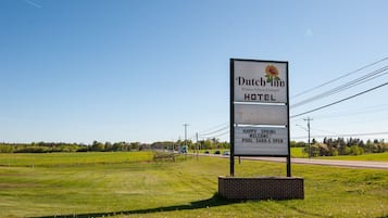 A sign for Dutch Inn Prince Edward Island Hotel with a message welcoming visitors to the pool area.