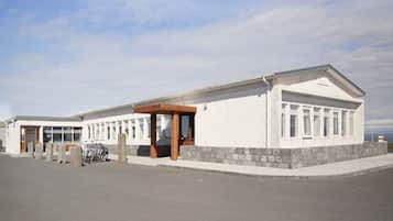 Standalone building with a central entrance and stone base.