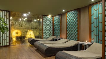 A spa room with tatami mats, a low wooden table, and a wall with geometric patterns.