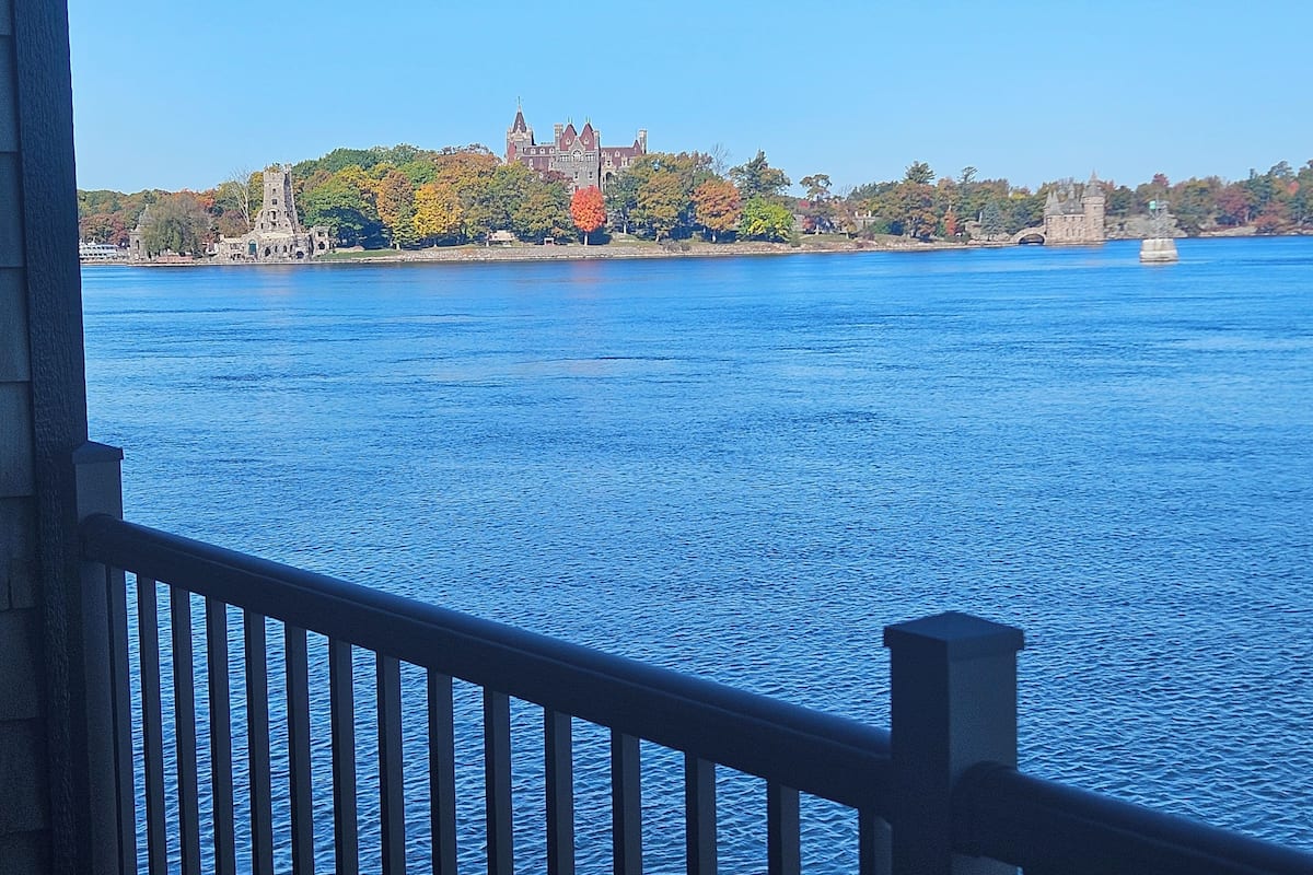 A view of a large body of water with a historic building in the background.