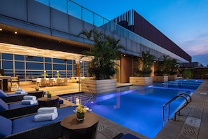 Seasonal outdoor pool, open 10:00 AM to 7:00 PM, pool umbrellas
