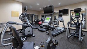 A gym with treadmills, elliptical machines, and weight machines. - Candlewood Suites Grove City - Outlet Center by IHG (Mercer)