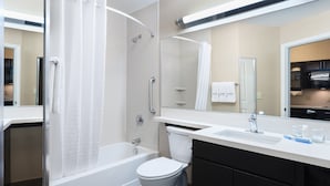A modern bathroom with a shower, toilet, and sink. - Candlewood Suites Grove City - Outlet Center by IHG (Mercer)