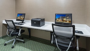 A hotel room with two desks, each equipped with a computer monitor, keyboard, and mouse. - Candlewood Suites Grove City - Outlet Center by IHG (Mercer)