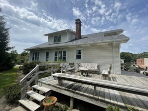 A two-story house with a wooden deck, a brick chimney, and a 'No Golf' sign. - The John Butler House Bed & Breakfast (Elizabeth)