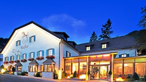 A hotel with a traditional European architectural style, featuring a prominent facade with a sign reading "Stafler."