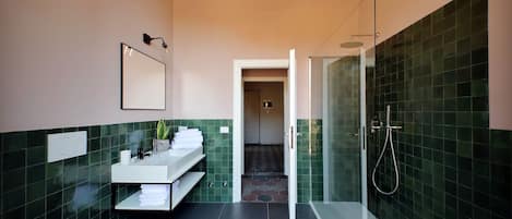 A modern bathroom with a toilet, sink, and shower area.